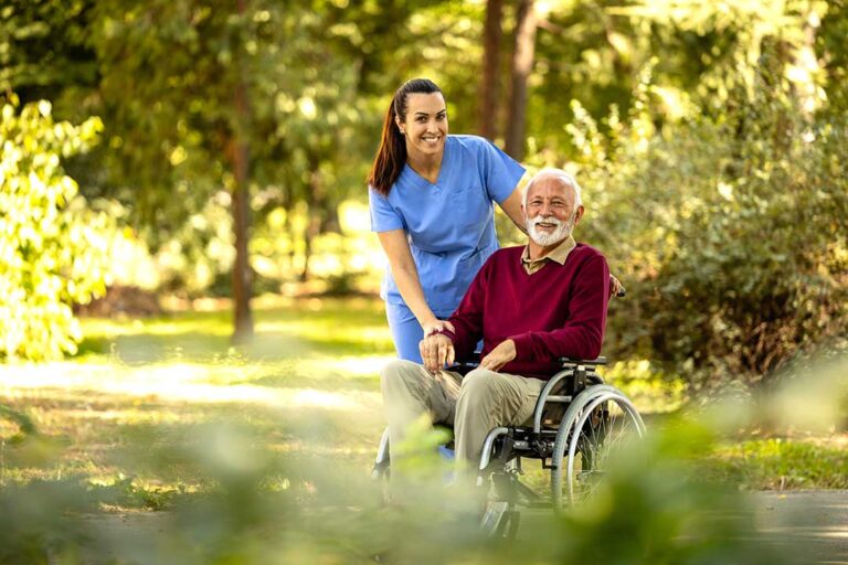 Nurse and older resident reviewing a medication list and appointment calendar at a table.